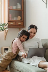 Mamma e figlia navigano insieme il web su un laptop